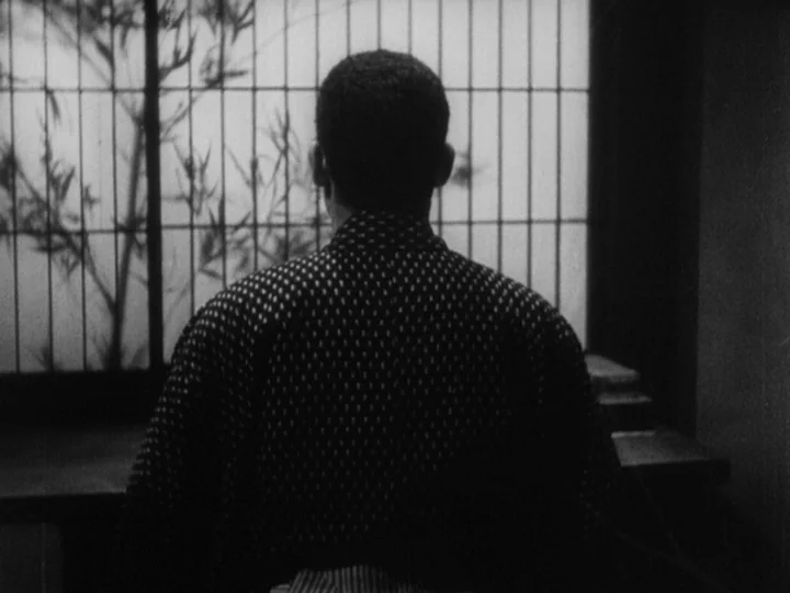 Sanshiro Sugata (1943) movie still: medium — A traditional Japanese room features a large sliding paper screen with wooden lattices. A man sits…