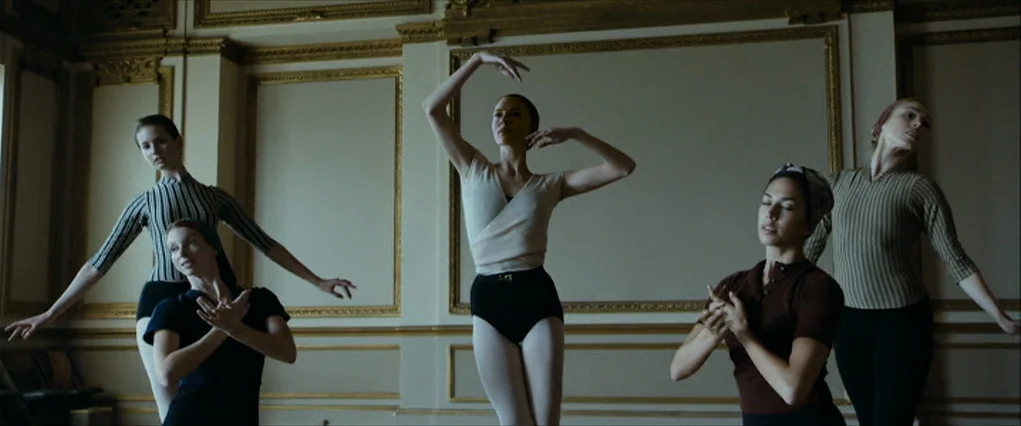 The Curious Case Of Benjamin Button (2008) movie still: wide — A spacious rehearsal room features gold-trimmed paneling on cream colored walls. Five…