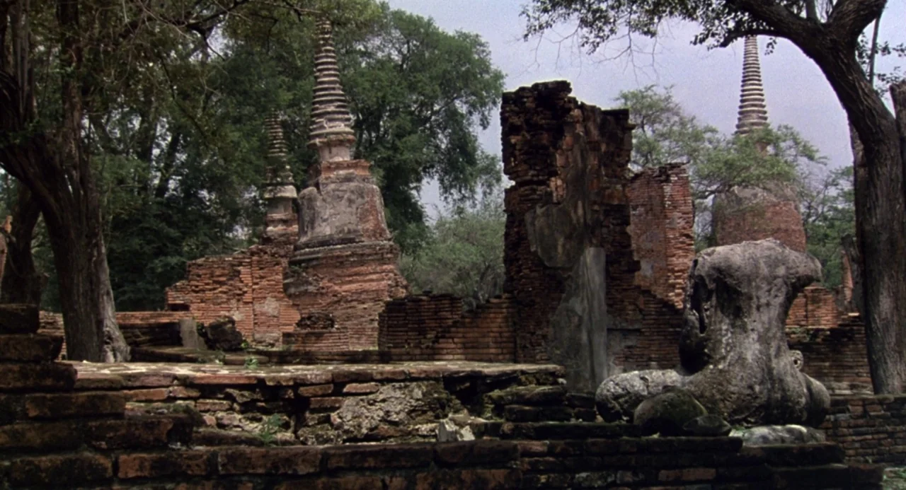 Godzilla and Mothra: The Battle for Earth (1992) movie still: wide — Weathered brick ruins of a temple complex stand surrounded by mature green…