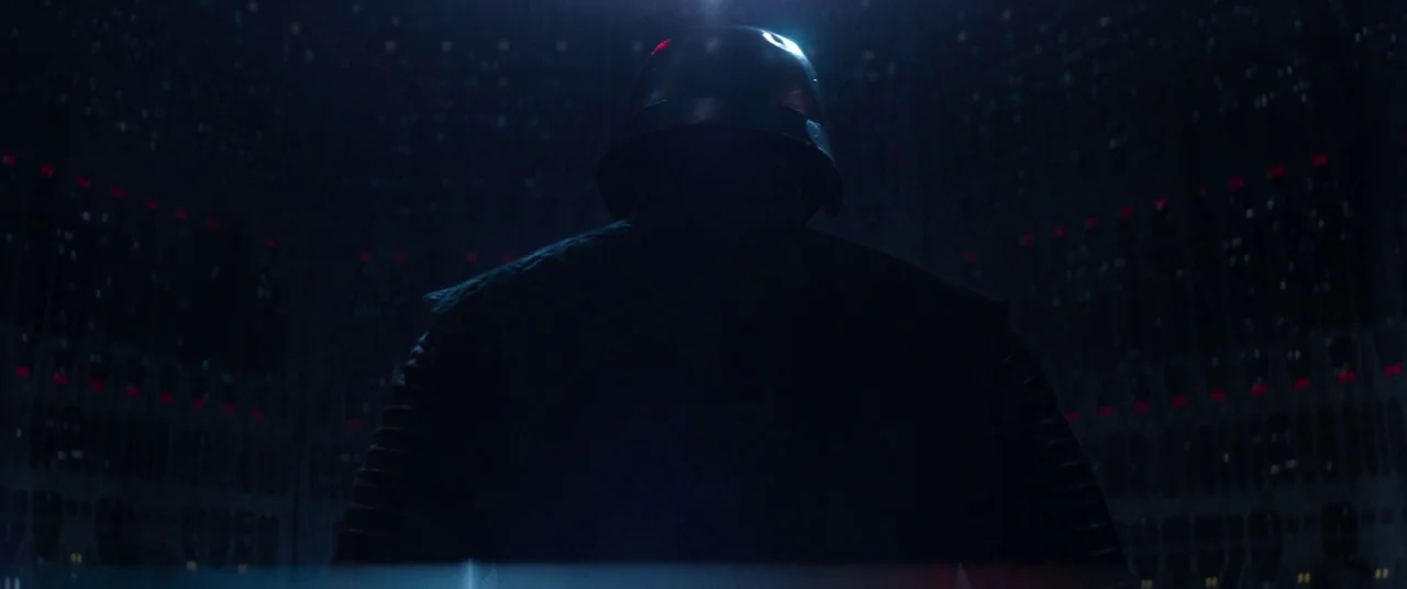 Star Wars: The Force Awakens (2015) movie still: medium — A dark, enclosed space features rows of repeating red lights along the distant walls. A…