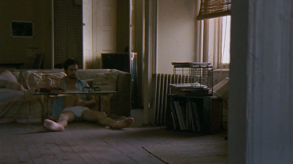 Half Nelson (2006) movie still: wide — A sparsely furnished apartment contains a sofa, a metal record storage rack, and radiator. A man in his…