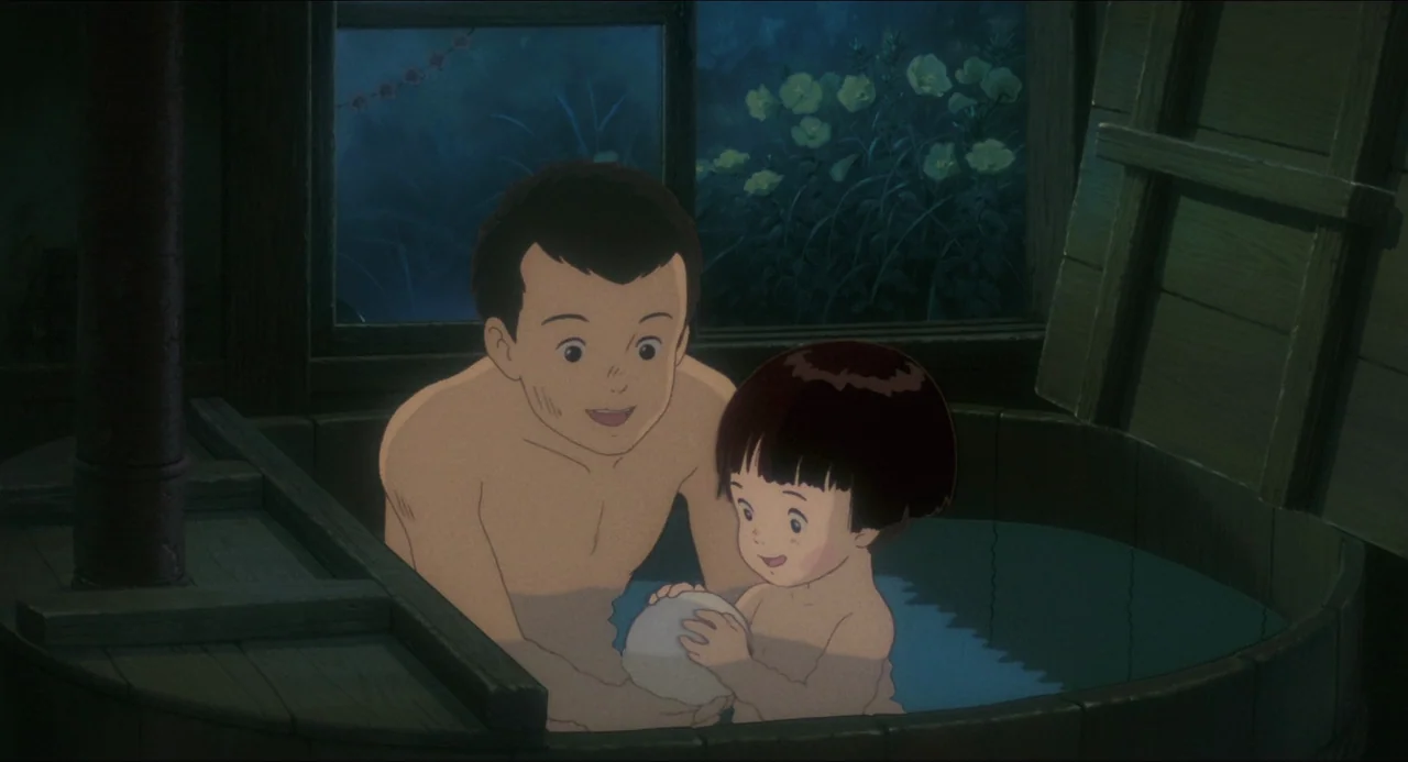 Grave of the Fireflies (1988) movie still: medium — A man and a child are inside a round wooden tub at night. They play with a white ball while…