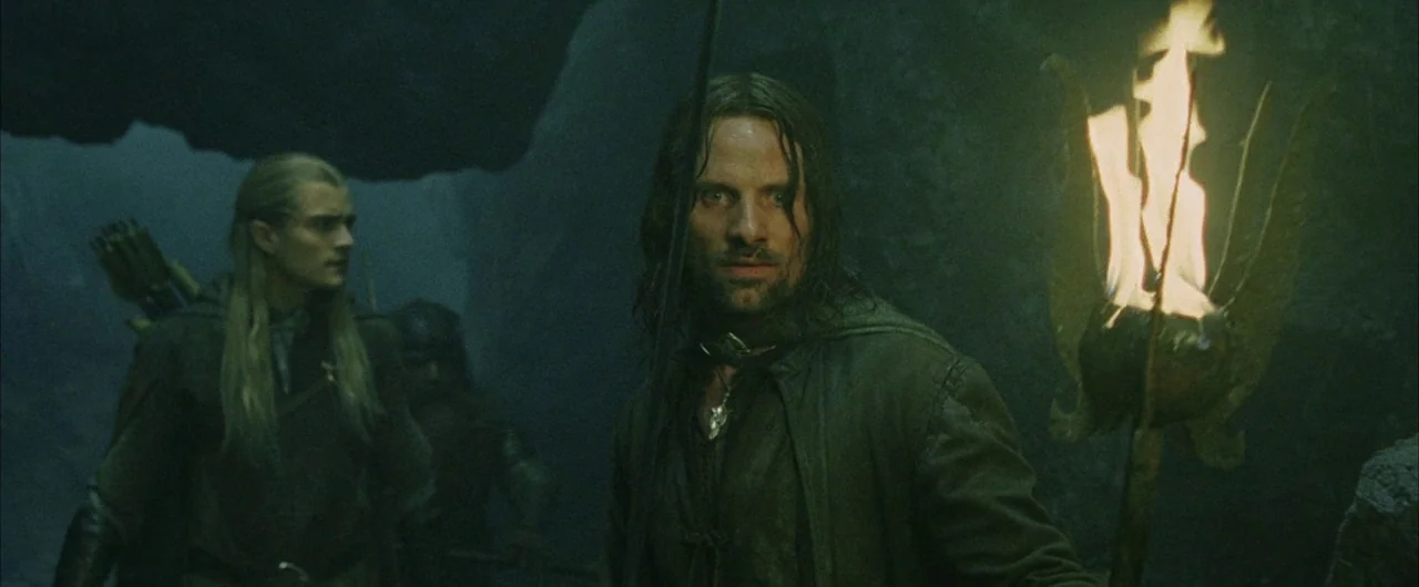 The Lord of The Rings: The Return of the King (2003) movie still: medium — A dark, rocky underground cave interior with uneven walls and shadows. A…
