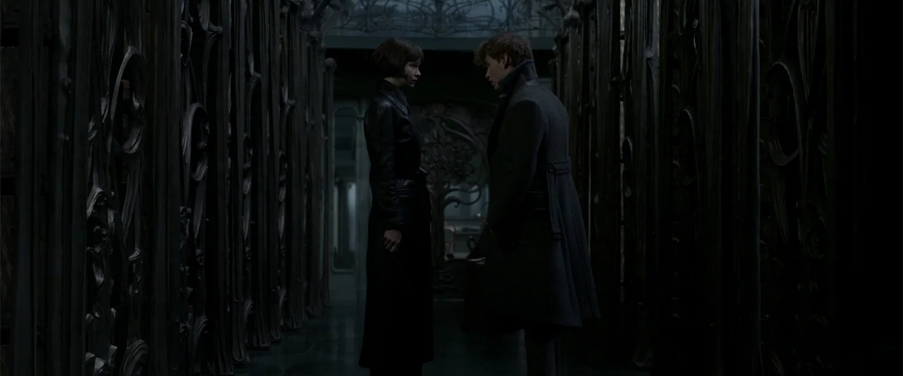 Fantastic Beasts: The Crimes of Grindelwald (2018) movie still: fullbody — A dark, narrow stone hallway features intricate, ornate metal work on…