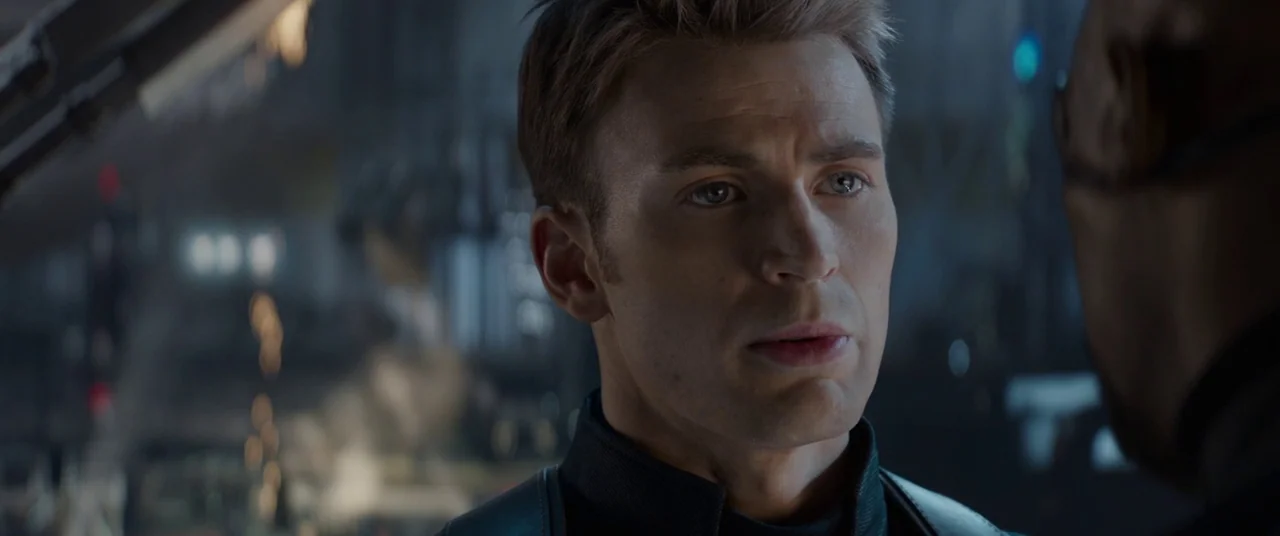 Captain America: The Winter Soldier (2014) movie still: closeup — A high-tech command deck with dark metallic surfaces and blurry background…