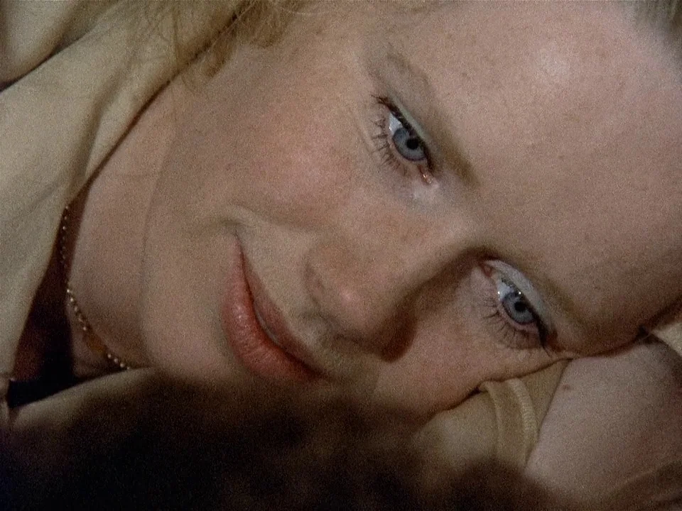 Scenes from a Marriage (1973) movie still: closeup — A close view of a person resting in a bedroom. The subject lies on their side with their head…