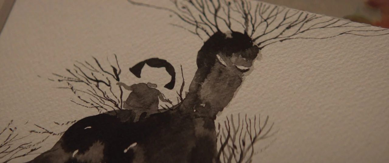 A Monster Calls (2016) movie still: closeup — A close-up view shows an ink and watercolor drawing on a piece of paper. The drawing depicts a small…