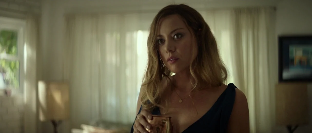 Ingrid Goes West (2017) movie still: medium — A residential interior features sheer white curtains covering a large window at the rear. A woman…