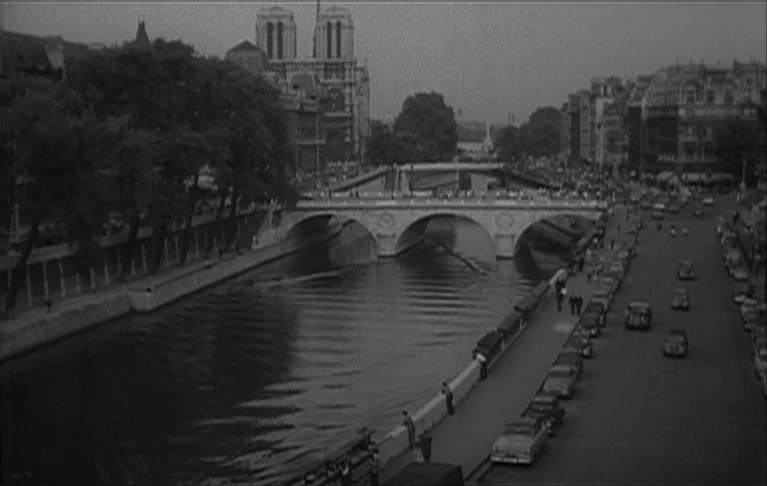 Le Signe du Lion (1962) movie still: establishing — A high-angle view of the Seine river flowing past the Notre-Dame Cathedral in Paris. Vintage…