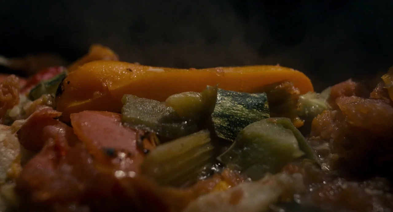 Berberian Sound Studio (2012) movie still: closeup — Various chopped vegetables are simmering together in a dark metallic cooking vessel. The…