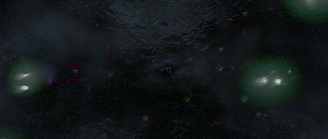 The Mothman Prophecies (2002) movie still: establishing — The dark, rippling surface of a large body of water at night. Numerous small, brightly…