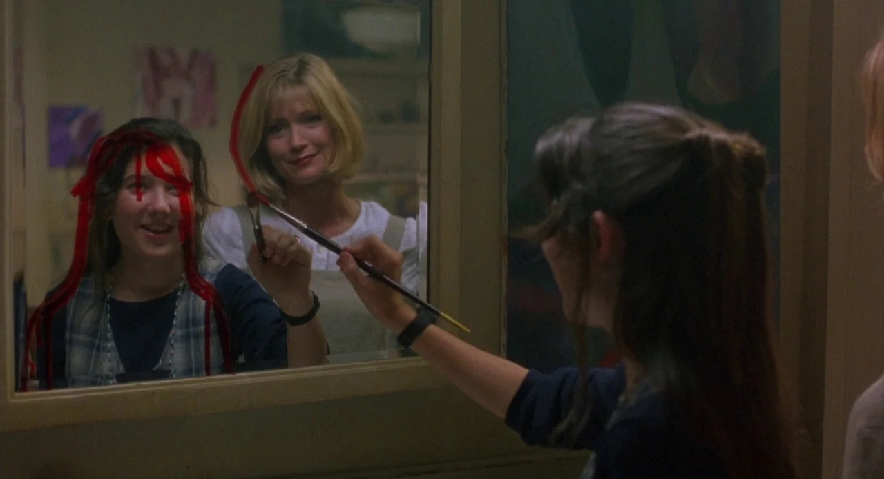 Candyman: Farewell to the Flesh (1995) movie still: medium — A bathroom interior with a large wall mirror displaying a reflection of two people. A…
