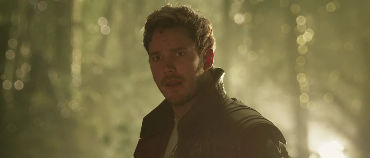 Guardians of the Galaxy Vol. 2 (2017) movie still: medium — A man stands in a brightly lit, out-of-focus woodland setting with dappled golden…