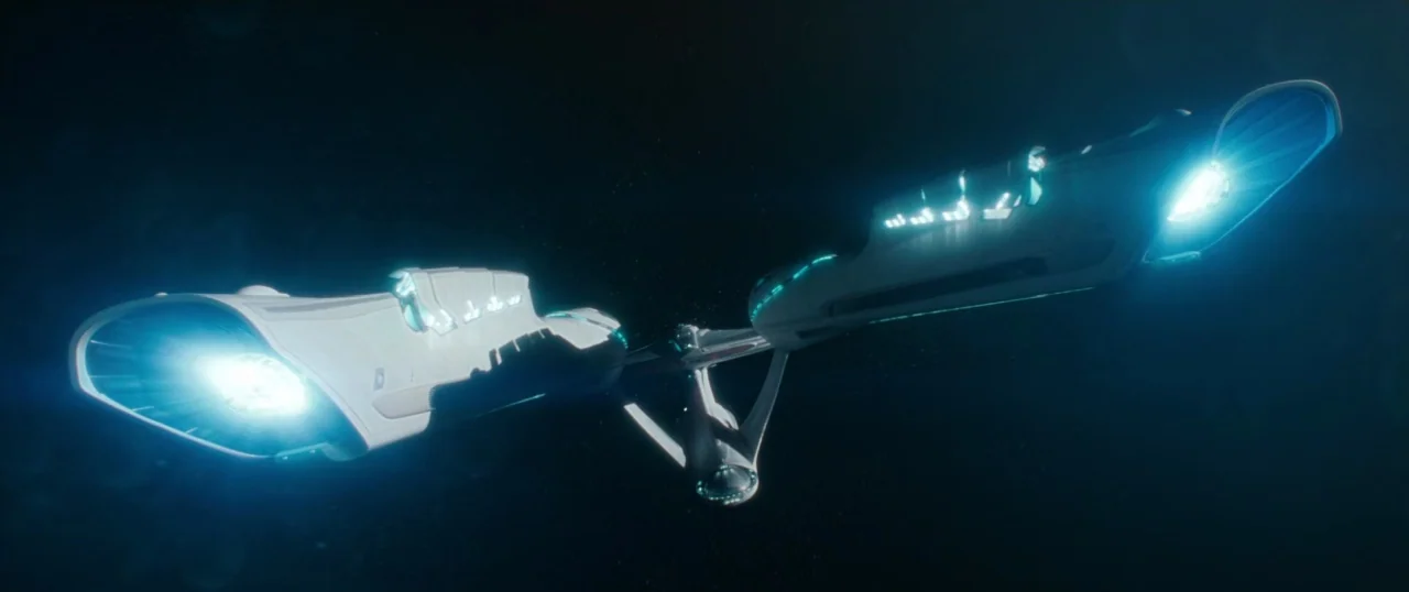 Star Trek Into Darkness (2013) movie still: wide — A sleek, futuristic starship travels through the dark expanse of deep space. Its two elongated…