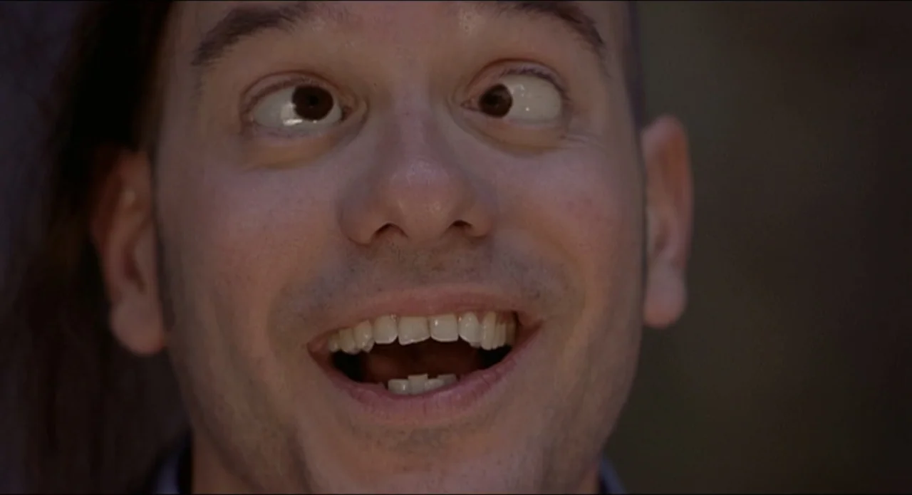 Scary Movie 2 (2001) movie still: closeup — A man's face dominates the frame in a plain indoor setting. He is looking directly at the camera with…