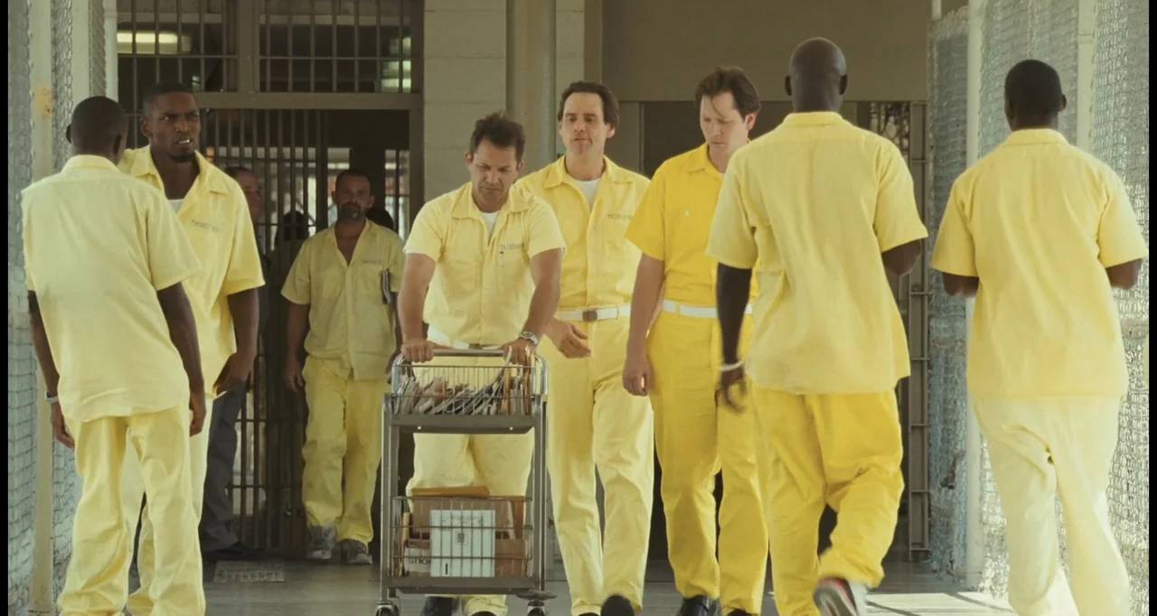 I Love You Phillip Morris (2010) movie still: fullbody — A long, institutional hallway features light-colored walls and metal chain-link security…
