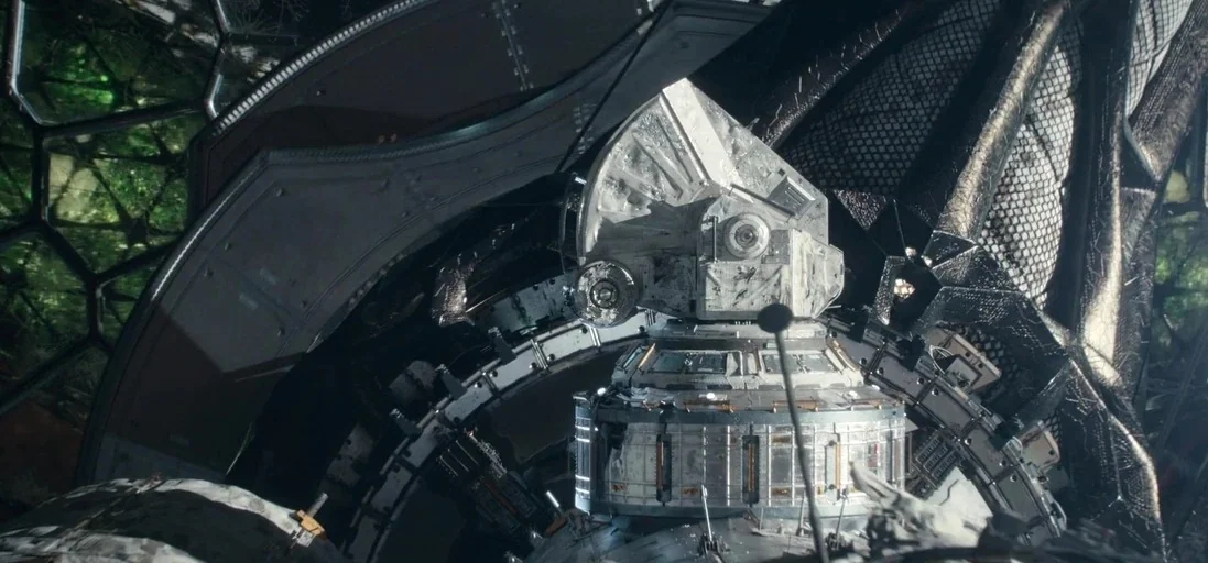 The Midnight Sky (2020) movie still: wide — A complex metallic interior features a central circular module within a large grid frame. The mechanical…