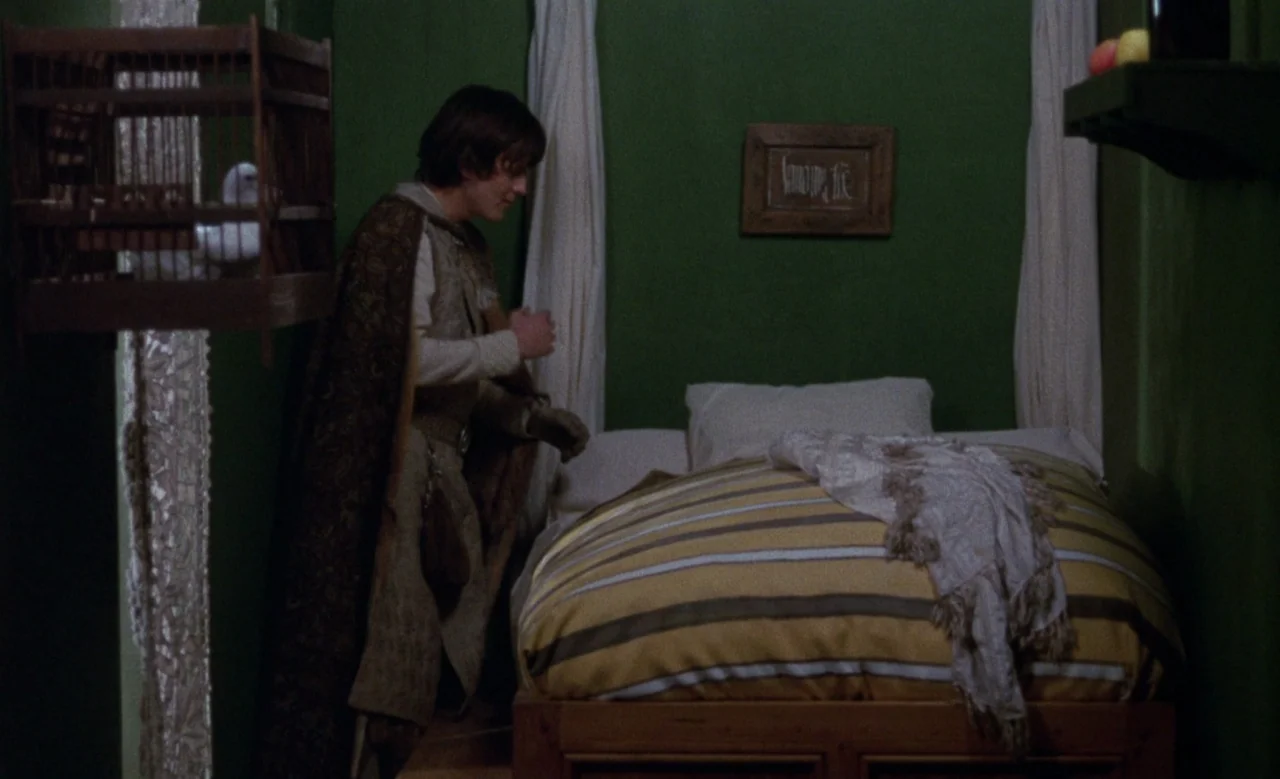 Blanche (1971) movie still: medium — A small room features vivid green walls and a single bed with striped bedding. A young man in medieval attire…