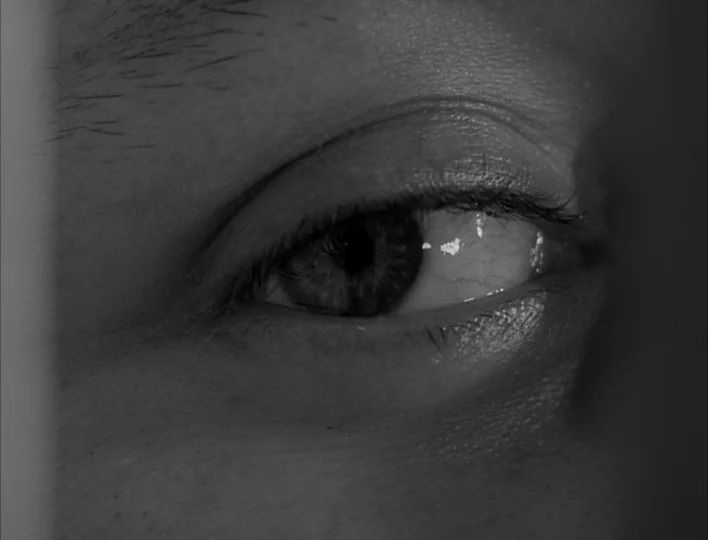 Carnival of Souls (1962) movie still: closeup — An extreme close-up focuses on a human eye framed within a dark environment. The eye looks towards…