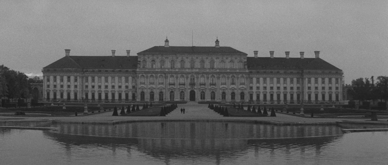 Last Year at Marienbad (1961) movie still: establishing — A massive, symmetrical 18th-century Baroque palace features a long horizontal facade and…