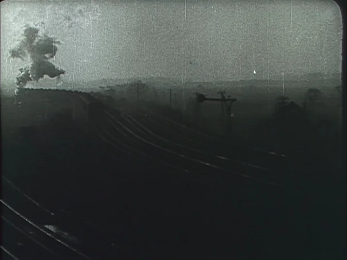 Making of: The Wheel (La Roue) (1923) movie still: establishing — A steam train travels along dark railway lines cutting through a foggy rural…