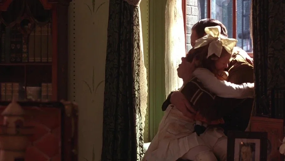 A Little Princess (1995) movie still: medium — A dimly lit room features a tall bookshelf and a window draped with heavy fabric. A man in uniform…