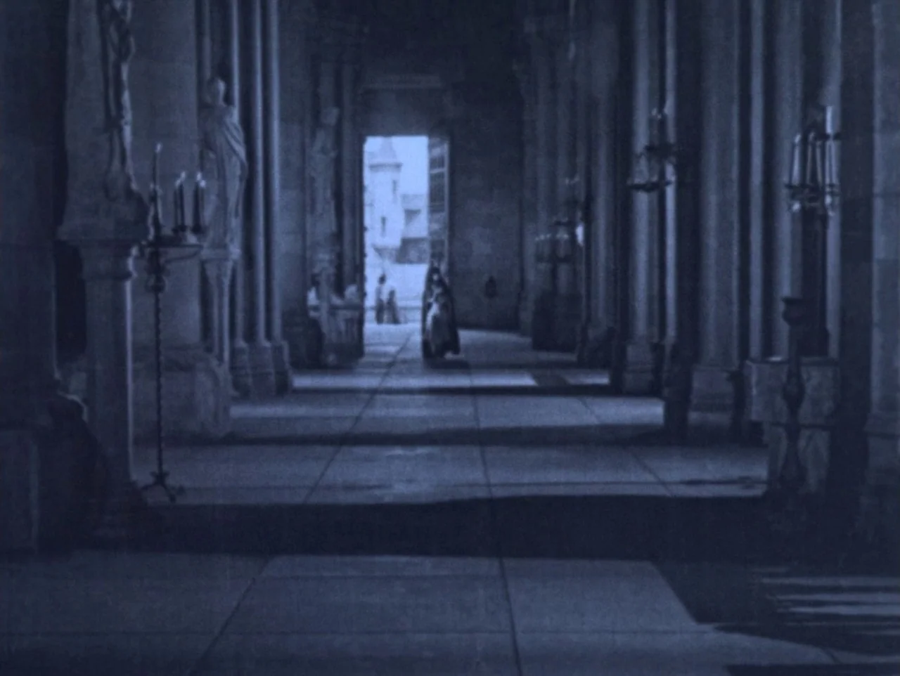 The Hunchback of Notre Dame (1923) movie still: wide — A long cathedral nave with stone pillars and tiled floors stretches toward an opening. A…