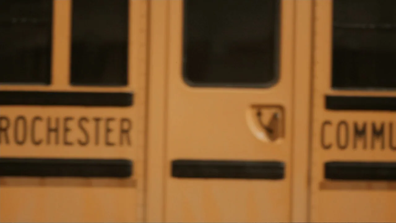 Aileen Wuornos : Mind of a Monster (2020) movie still: medium — A close-up of a yellow school bus side panel featuring black lettering. The word…