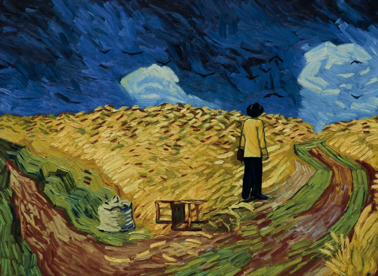 Loving Vincent (2017) movie still: wide — A vast golden grain field under a dark, heavy blue sky with scattered clouds. A man stands at the edge of…