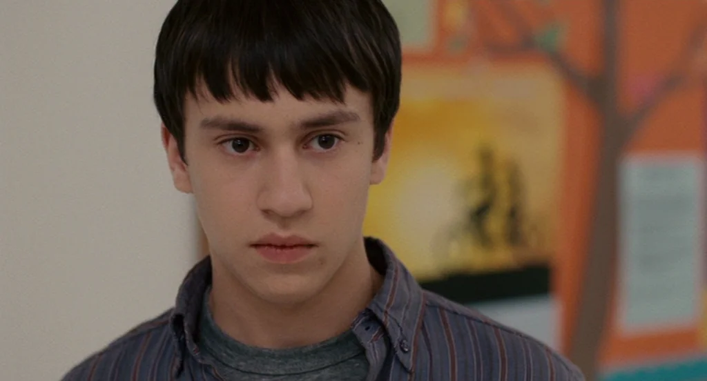 It’s Kind Of A Funny Story (2010) movie still: closeup — A close-up of a teenage boy in what appears to be a classroom. He stares blankly forward…