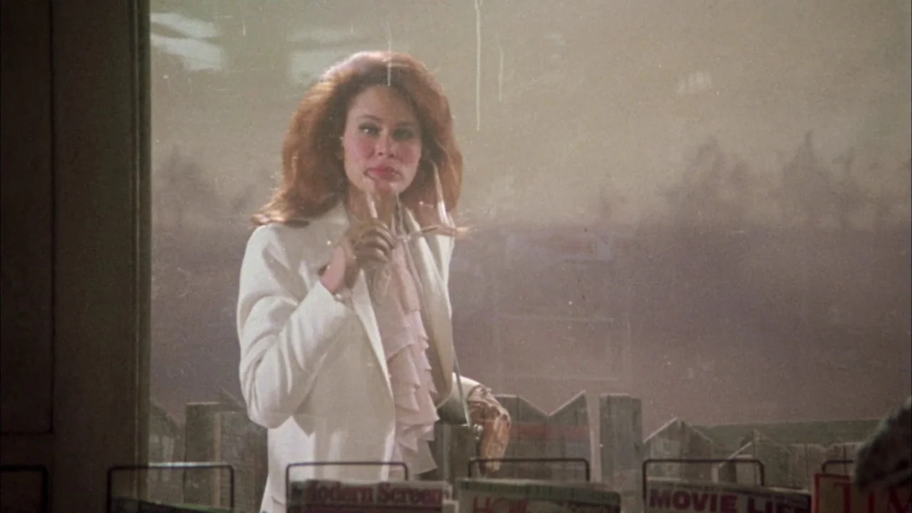 Come Back to the 5 & Dime Jimmy Dean, Jimmy Dean (1982) movie still: medium — A woman stands behind the glass display window of a newsstand or…