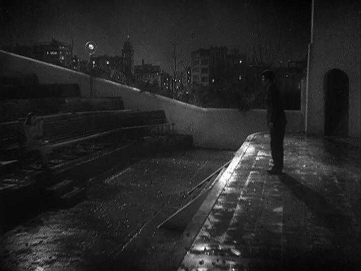 One Wonderful Sunday (1947) movie still: wide — An outdoor amphitheater at night features tiered concrete benches and a raised performance stage. A…