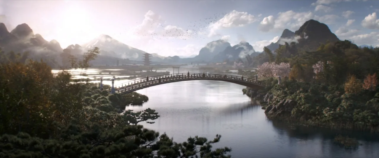 47 Ronin (2013) movie still: establishing — A landscape featuring a traditional wooden arched bridge over a calm body of water. Distant mountains…