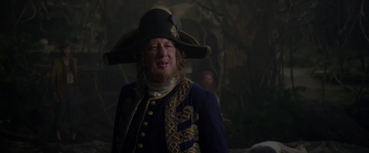 Pirates of the Caribbean: On Stranger Tides movie still: medium — A dark, dense jungle with tangled vines and shadowed foliage fills the background.…
