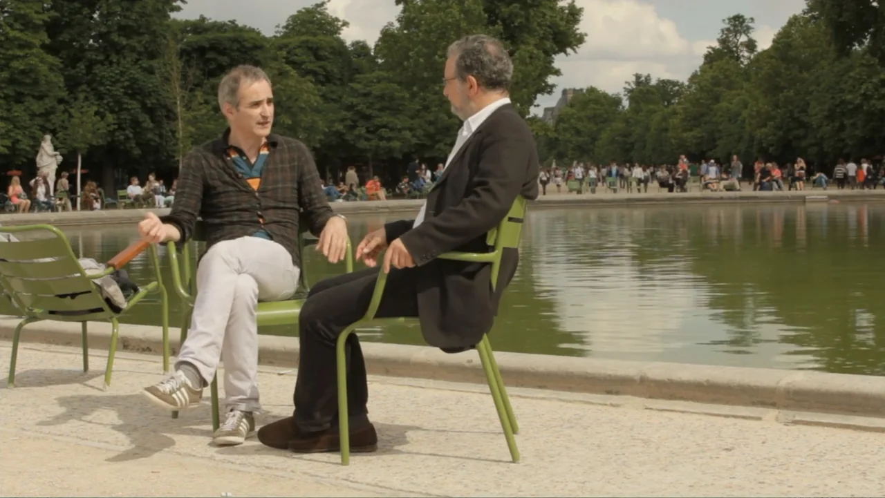 Flowers of Taipei: Taiwan New Cinema (2014) movie still: medium — Two men sit in outdoor green metal chairs by a park water feature. They are having…