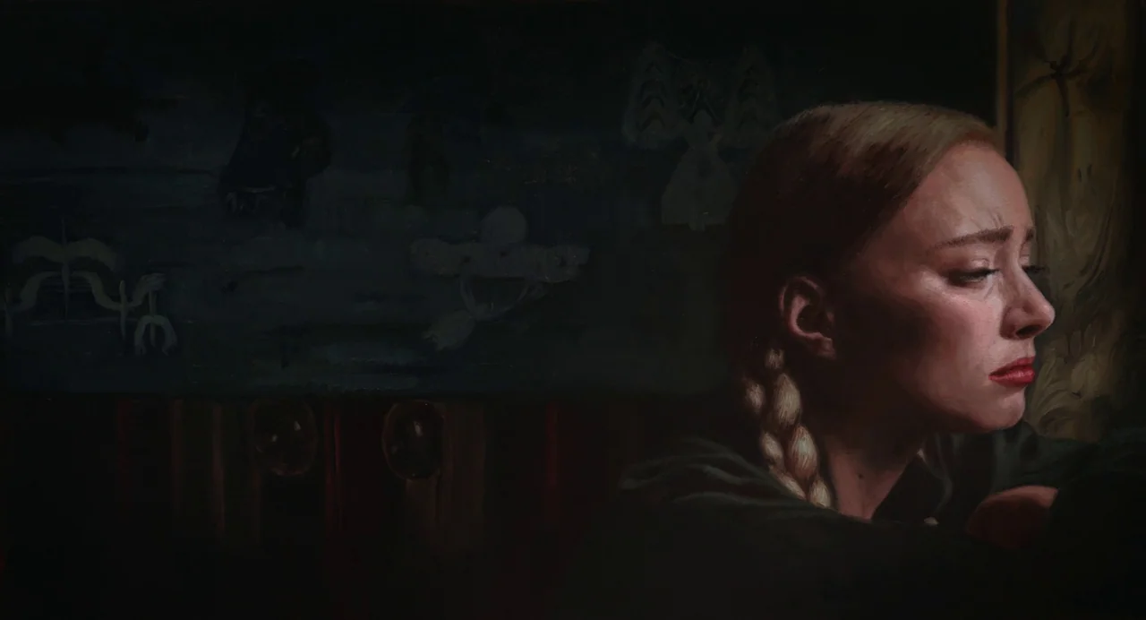 The Peasants (2023) movie still: closeup — A dark, dimly lit room contains a painted mural on the wall behind the subject. A blonde woman with a…