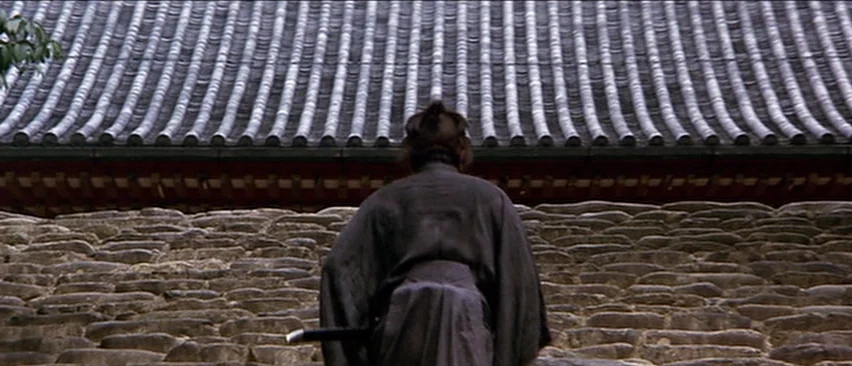 Lone Wolf and Cub: Baby Cart in the Land of Demons (1973) movie still: fullbody — An exterior view of a stone staircase leading up to a curved tile…