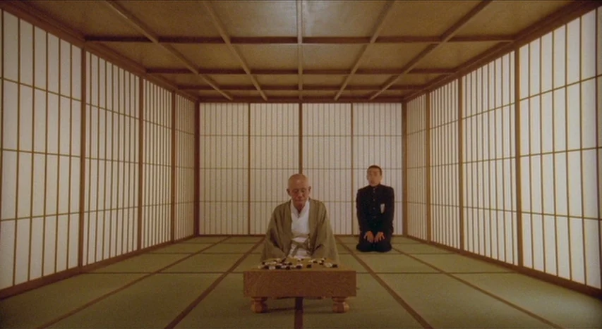 Mishima: A Life in Four Chapters (1985) movie still: wide — A symmetric interior space features tatami mats and floor-to-ceiling shoji screens on…