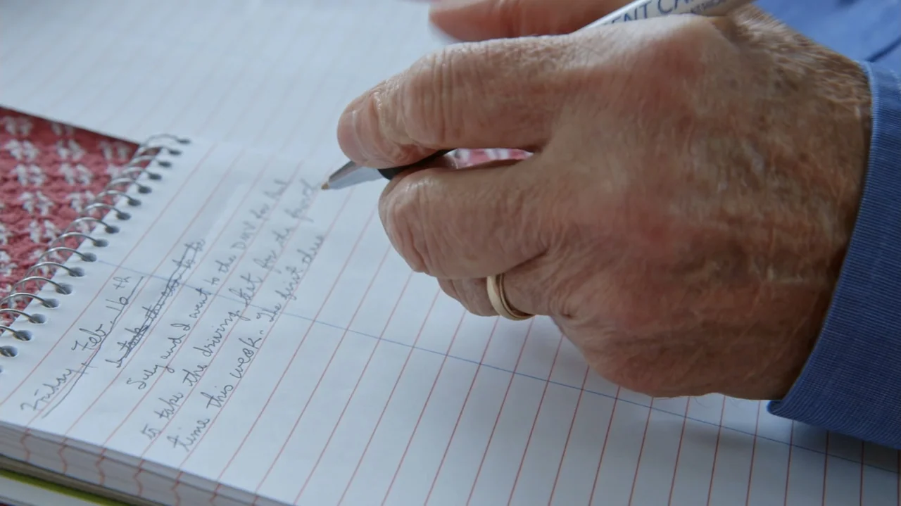 Moonlight Sonata: Deafness in Three Movements (2019) movie still: closeup — A notebook with lined pages sits on a flat surface with handwriting…