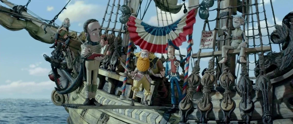 The Pirates! Band of Misfits (2012) movie still: wide — The wooden deck of a pirate ship is decorated with patriotic red and blue bunting. Several…