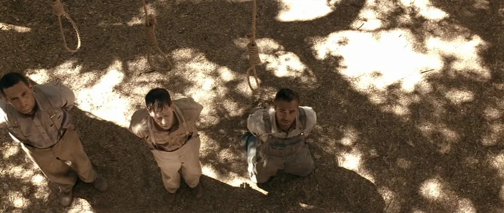 O Brother, Where Art Thou? (2000) movie still: wide — A dry, dirt-covered outdoor space features three nooses hanging from an overhead structure.…