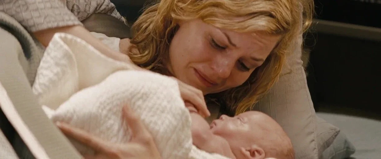 Star Trek (2009) movie still: closeup — A soft-lit hospital environment provides a setting for a mother and her newborn child. The mother cradles…