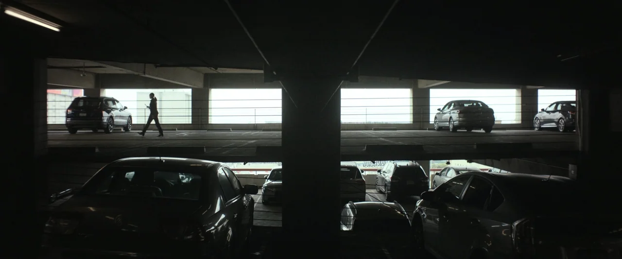 True Account: Breaking the Truce (Yakuza Bloody Chronicles 2) (2007) movie still: wide — A multilevel concrete parking garage contains rows of…