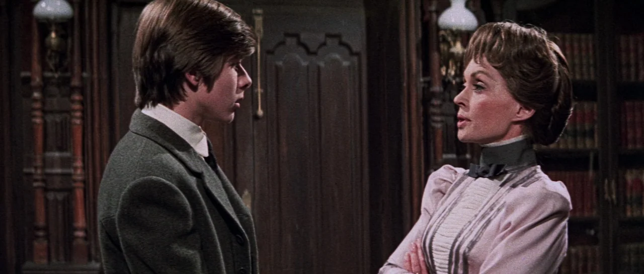 The House That Screamed (1969) movie still: medium — A dark wooden library with ornate wall panels and filled bookcases provides the backdrop. A…