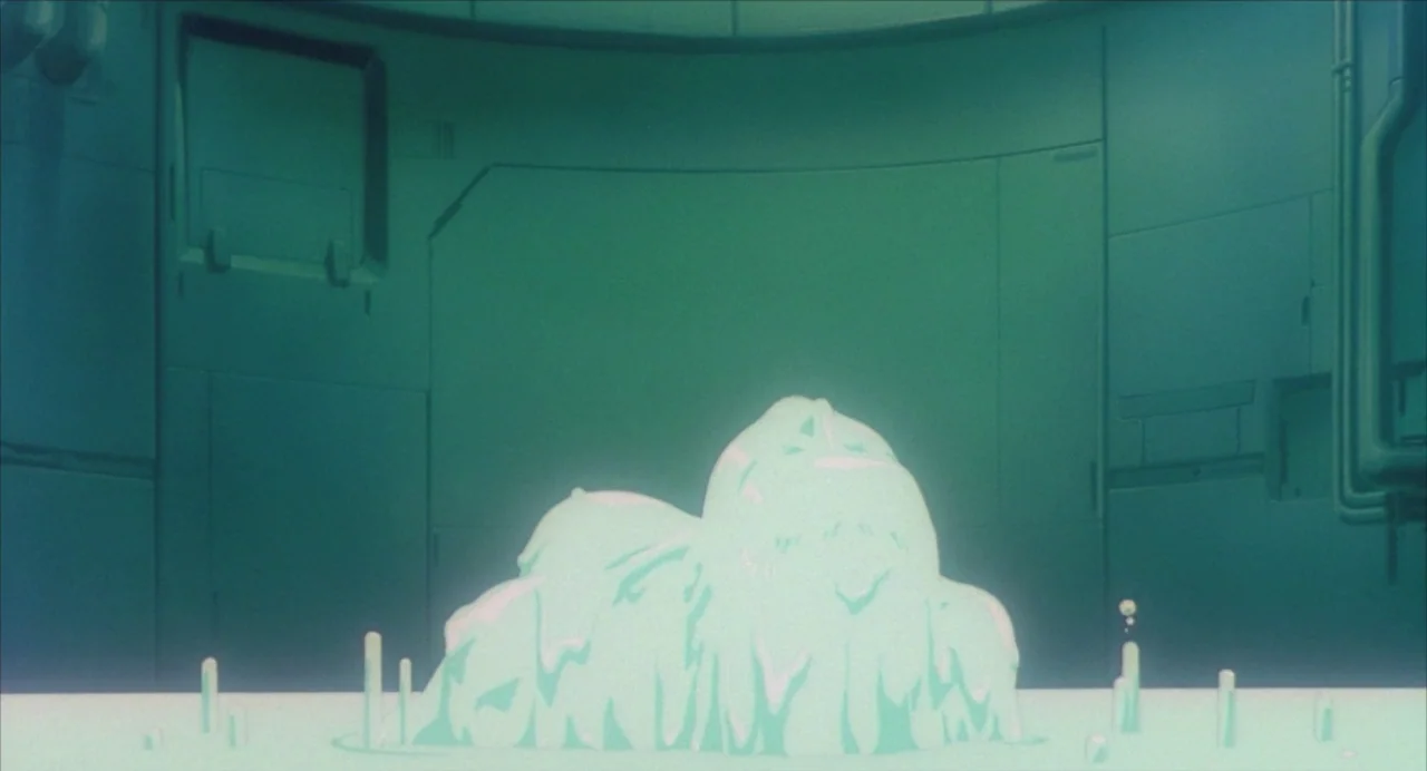 Ghost in the Shell (1995) movie still: wide — A curved metallic wall forms the background of a sterile, industrial-looking laboratory room. A pool…