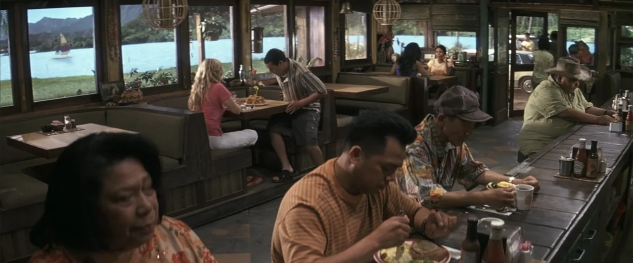 50 First Dates (2004) movie still: medium — A wooden restaurant interior features large windows overlooking a waterfront with a distant sailboat.…