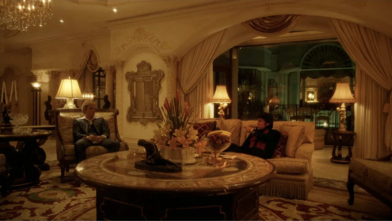 Behind the Candelabra (2013) movie still: wide — An opulent, expansive living room features ornate molding, heavy drapes, and antique-style…
