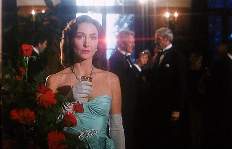 Lili Marleen (1981) movie still: medium — An elegant ballroom setting features a woman holding a drink among gala attendees. Background figures in…