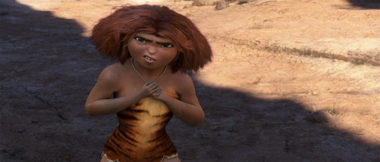The Croods (2013) movie still: medium — A dry desert landscape with cracked earth stretches out under bright daylight. A young woman with red hair…