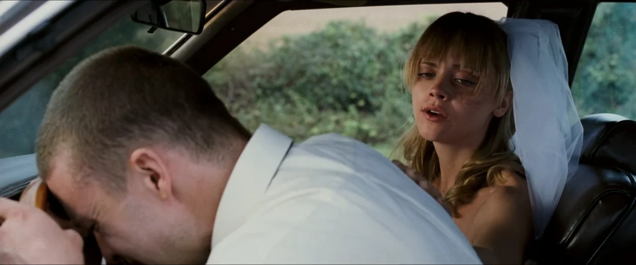 Black Snake Moan (2006) movie still: medium — A passenger seat inside a car with a view of green foliage outside window. A woman wearing a bridal…